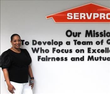 woman in front of mission statement