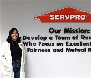 woman in front of mission statement