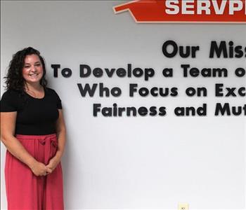 woman in front of mission statement